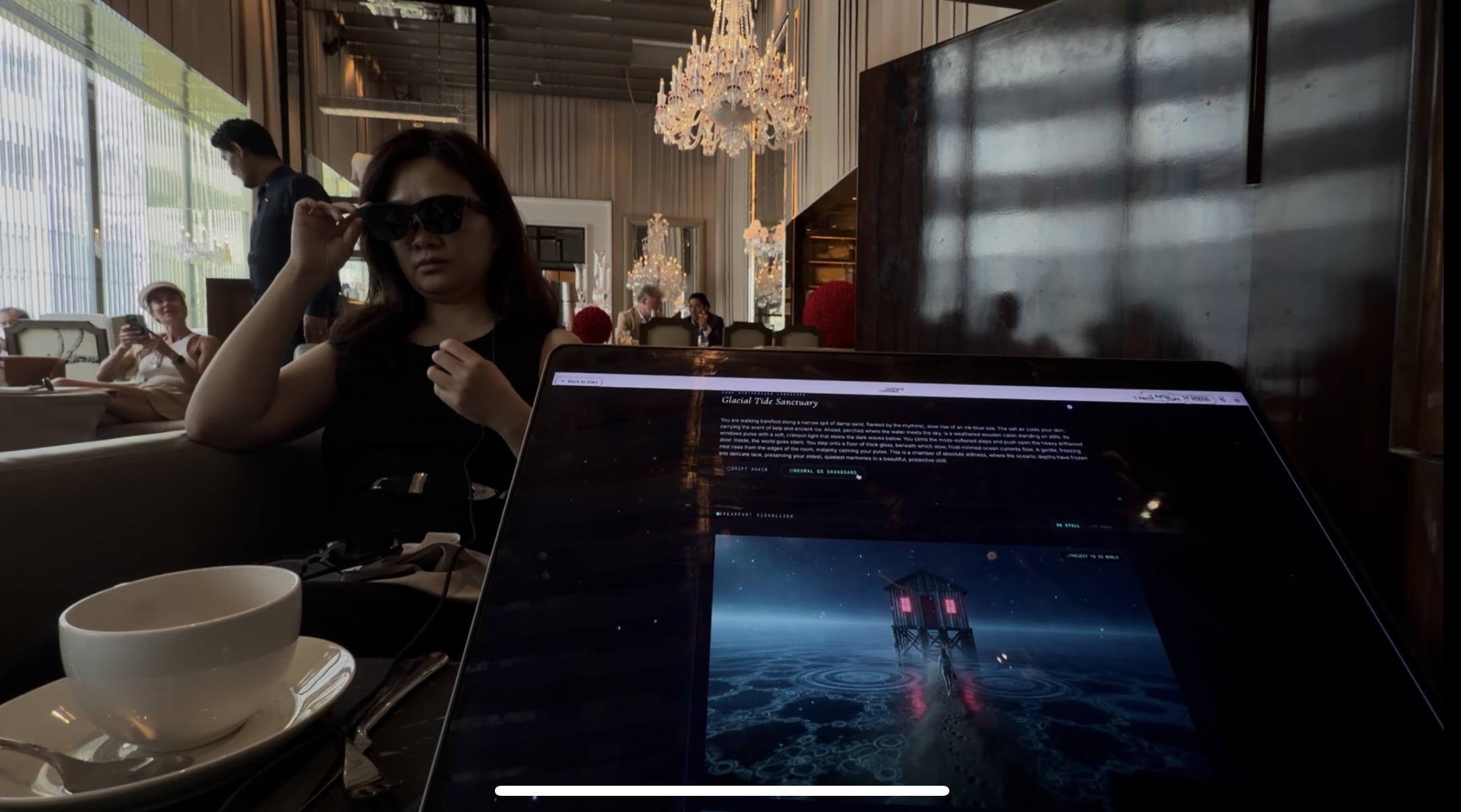 Dreama tester wearing glasses beside a laptop showing a dream world.