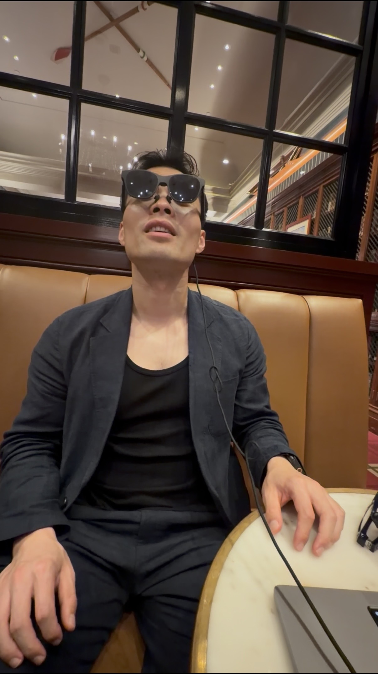 Tester wearing Dreama glasses during a seated trial.
