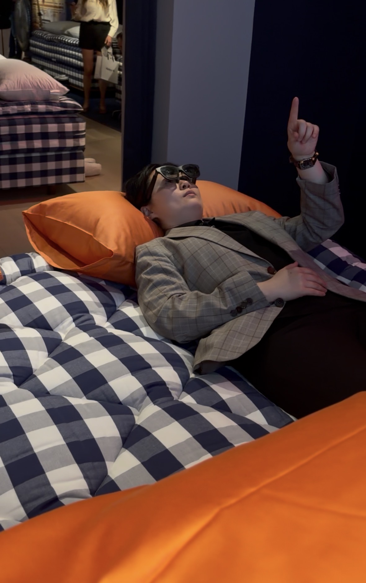 Tester lying on a bed wearing Dreama glasses.